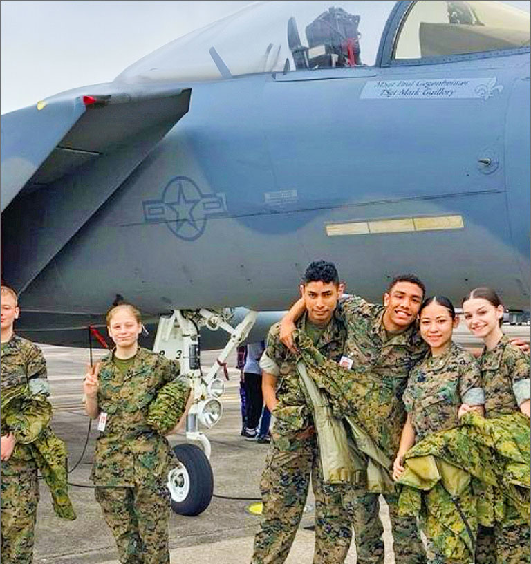 Cadets posing for photo in front of plane